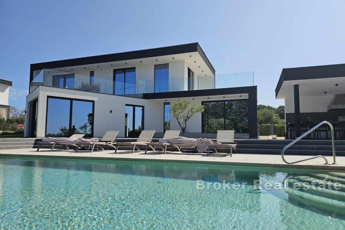 A modern villa surrounded by greenery in a quiet location