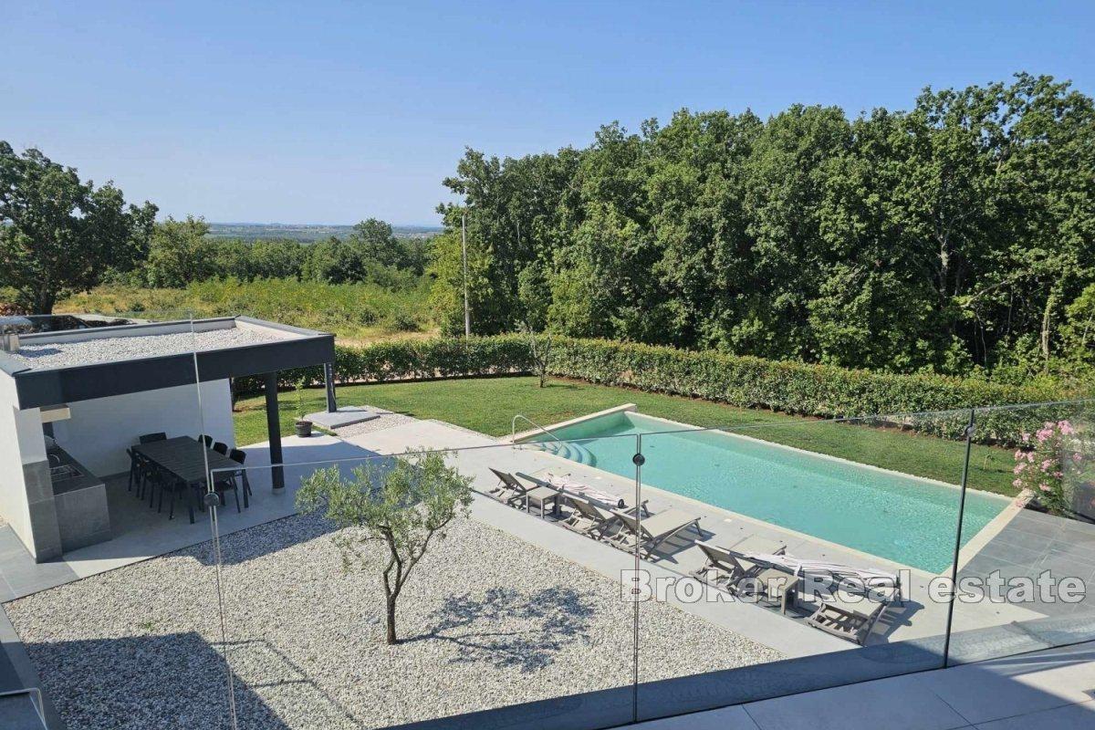 A modern villa surrounded by greenery in a quiet location