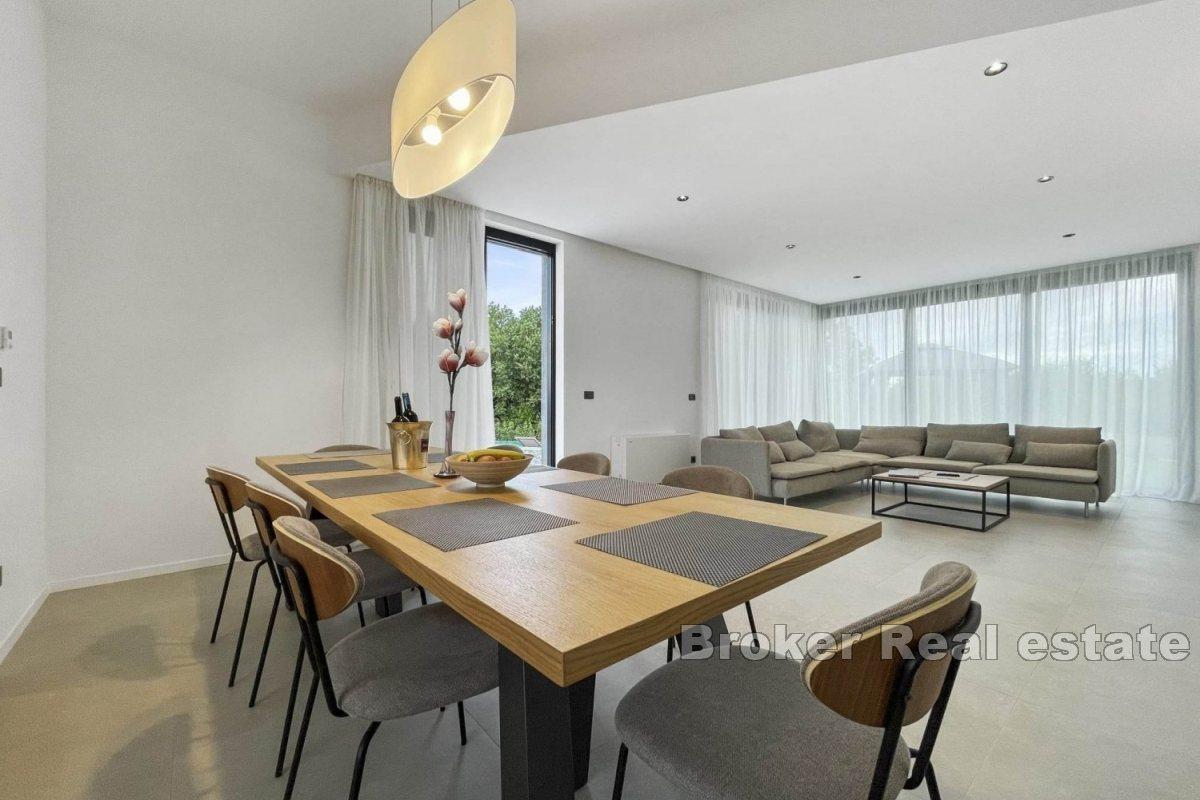 A modern villa surrounded by greenery in a quiet location