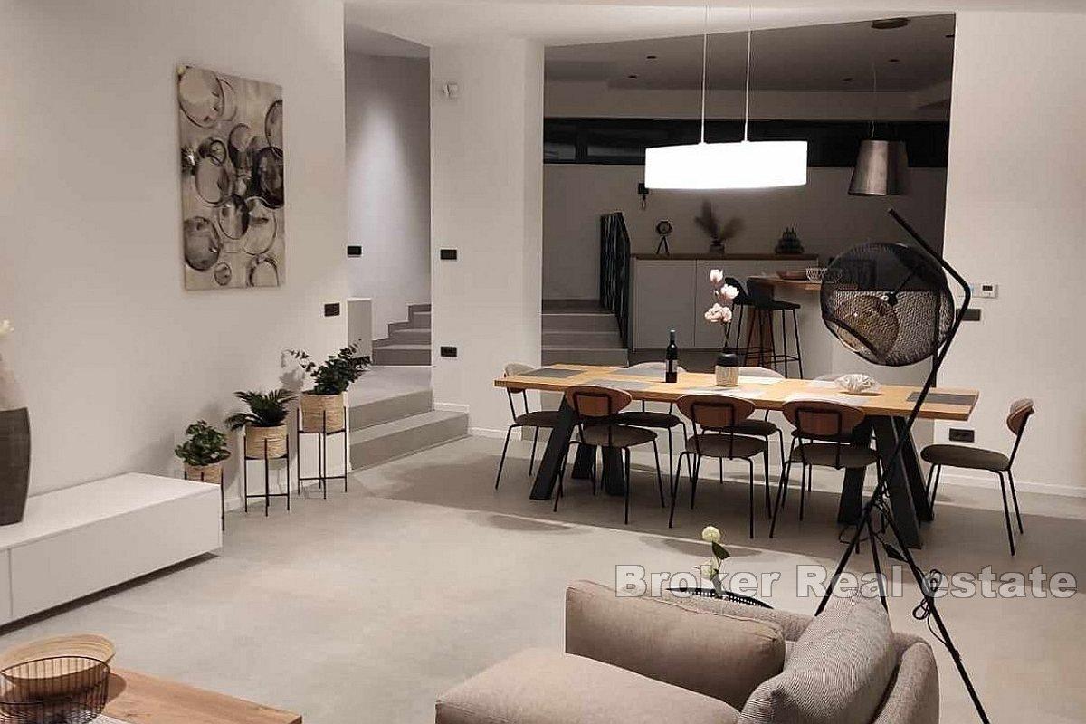 A modern villa surrounded by greenery in a quiet location